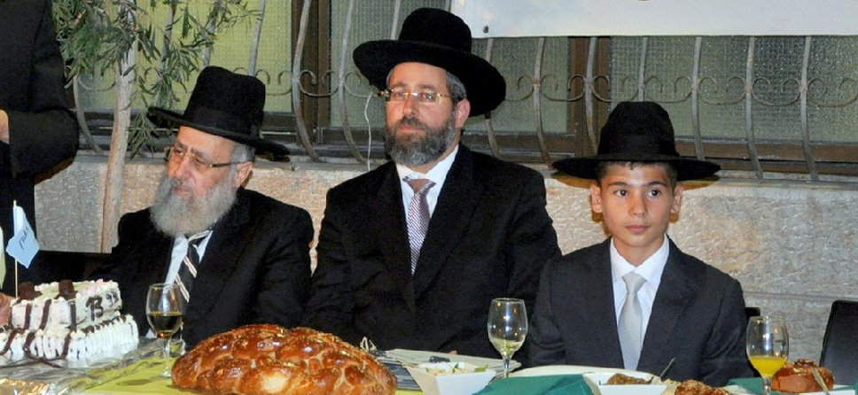 The current Chief Rabbis of Israel, Rabbi Yitzhak Yosef (L) and Rabbi David Lau (C), join a Zion boy's Bar Mitzvah celebration at the orphanage.