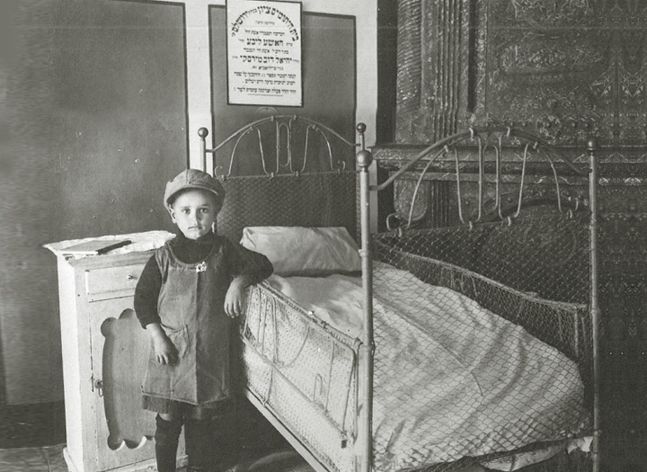 The framed picture above the bed displays the name of this Zion boy's sponsor.