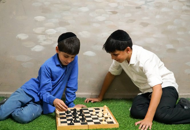 A couple of Zion boys enjoying an engaging game of chess