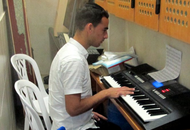 One of the older Zion boys practices keyboards during the afternoon break.
