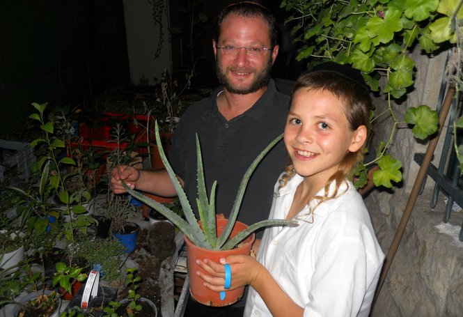 One of the Zion boys proudly shows a member of staff his nicely developing cactus plant.