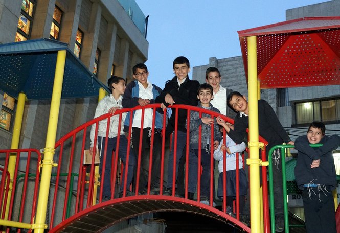 Some of the Zion boys pose for a picture from the campus playground which was donated by th...