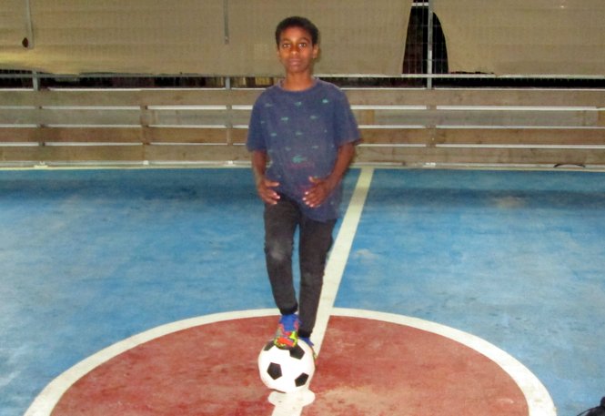 One of the Zion Orphanage boys prepares for an exciting early evening game of soccer on ou...