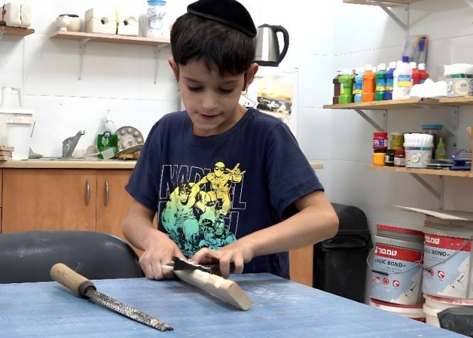 One of the Zion boys enjoying woodcarving in our arts and crafts program.