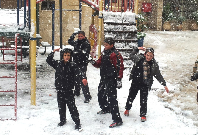 Snow falls in Jerusalem only once every few years. Here the Zion boys enjoy a good-nature...