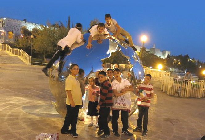 On an evening outing, Zion boys enjoy a sculpture located near Jaffa Gate in Jerusalem.